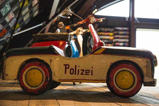 ged toy police car on a wooden shelf